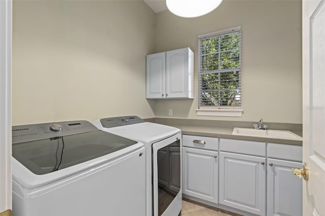 laundry area featuring independent washer and dryer, a sink, and cabinet space