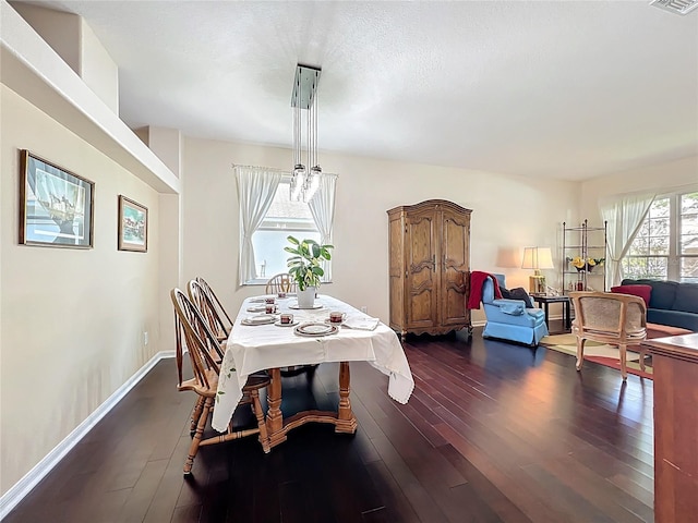 dining space featuring visible vents, baseboards, dark wood-type flooring, and a textured ceiling