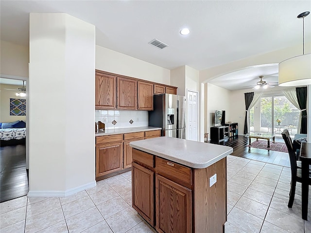 kitchen featuring visible vents, a ceiling fan, stainless steel fridge with ice dispenser, light countertops, and light tile patterned floors