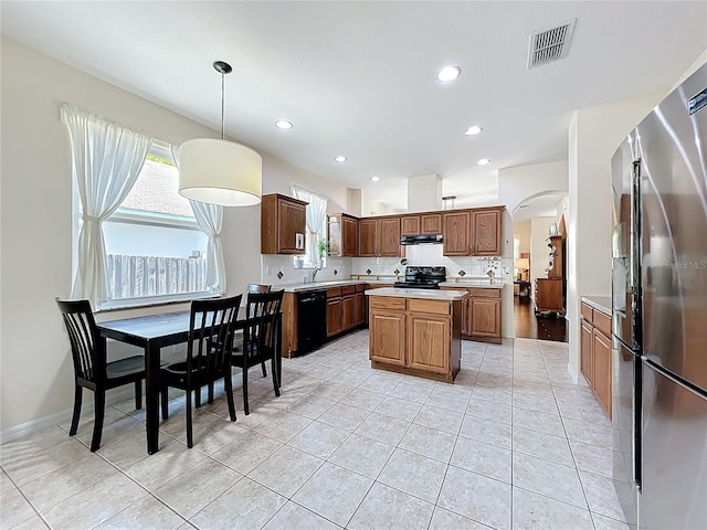 kitchen with visible vents, a center island, light countertops, exhaust hood, and black appliances