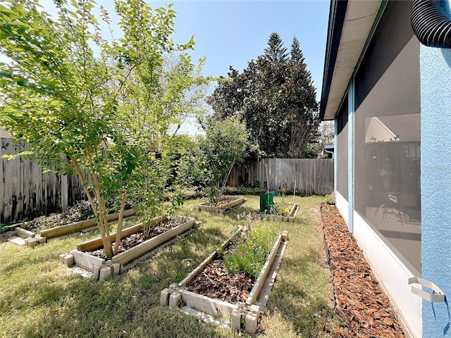 view of yard with a garden and a fenced backyard