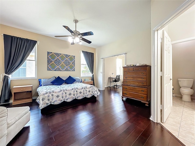 bedroom featuring a ceiling fan, baseboards, and wood finished floors