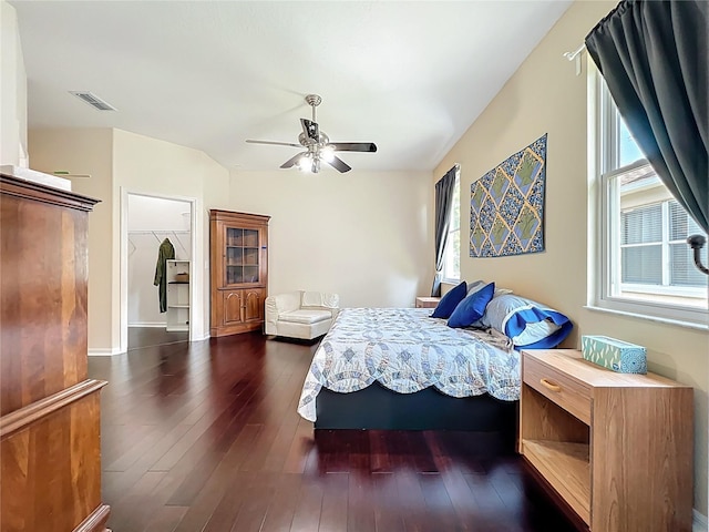 bedroom with visible vents, dark wood-style floors, and a ceiling fan