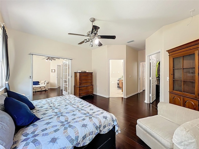 bedroom with visible vents, baseboards, ceiling fan, dark wood finished floors, and ensuite bathroom