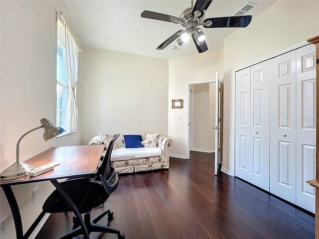 office area featuring dark wood-type flooring, baseboards, visible vents, and ceiling fan