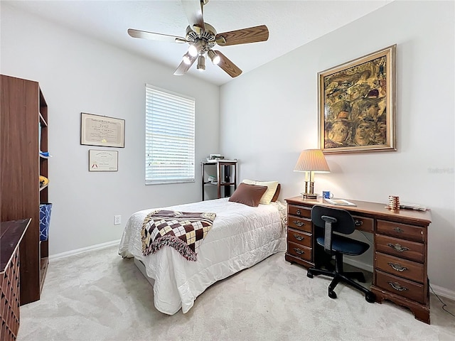 bedroom with baseboards, light colored carpet, and a ceiling fan