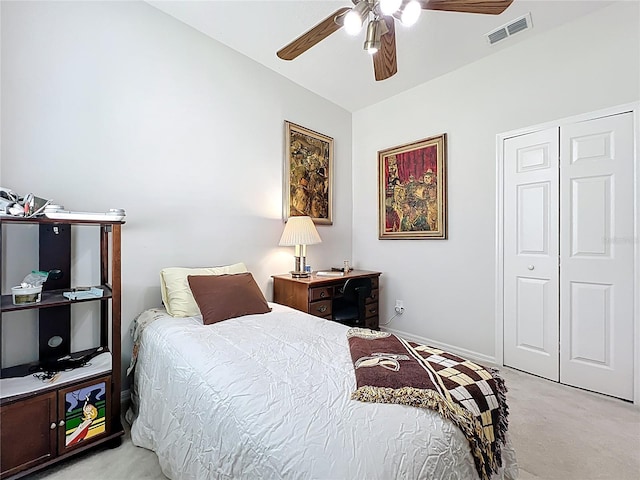 bedroom with a ceiling fan, visible vents, baseboards, a closet, and light colored carpet