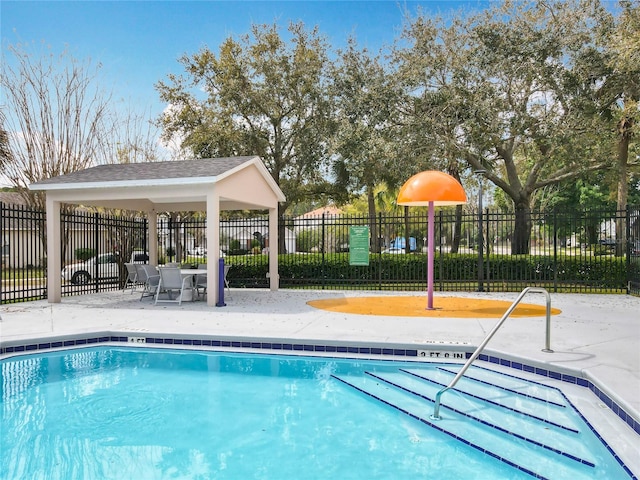 community pool featuring a patio area and fence