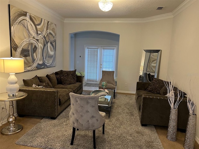 living room with carpet floors, french doors, visible vents, ornamental molding, and baseboards