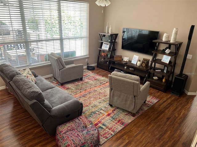 living room featuring dark wood-style floors and baseboards