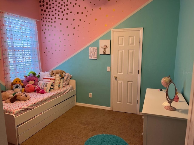 carpeted bedroom with lofted ceiling and baseboards