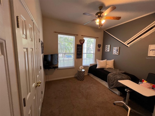 bedroom with dark colored carpet, ceiling fan, and baseboards