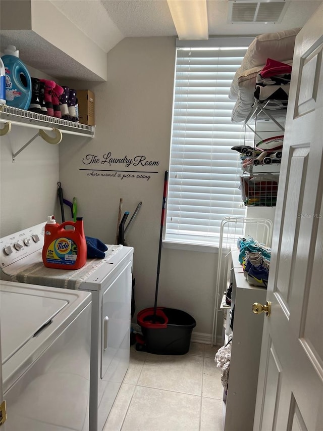 laundry room featuring light tile patterned floors, laundry area, visible vents, baseboards, and independent washer and dryer