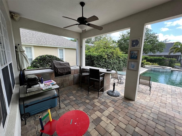 view of patio / terrace with outdoor dry bar, a pool with connected hot tub, grilling area, area for grilling, and ceiling fan