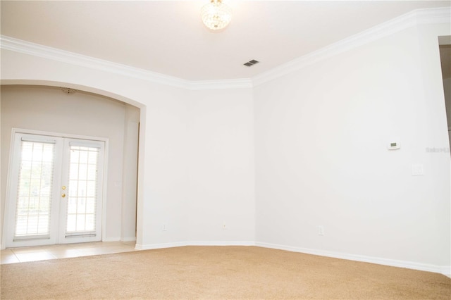11474 Claymont Cir, Windermere, FL 34786 - empty room featuring arched walkways, light carpet, ornamental molding, and french doors