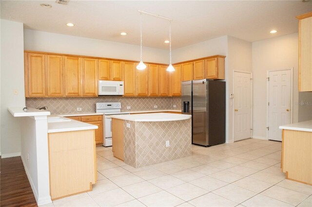 11474 Claymont Cir, Windermere, FL 34786 - kitchen featuring white appliances, light countertops, backsplash, a center island, and recessed lighting