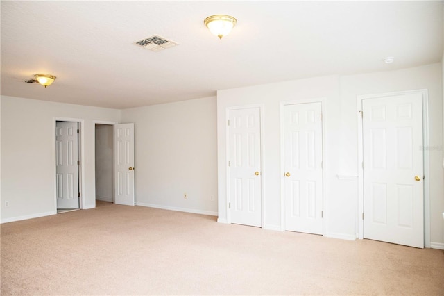 11474 Claymont Cir, Windermere, FL 34786 - unfurnished bedroom featuring light carpet and multiple closets