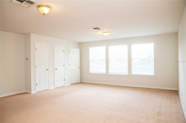 11474 Claymont Cir, Windermere, FL 34786 - unfurnished bedroom featuring light colored carpet and multiple closets