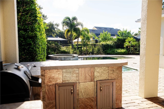 11474 Claymont Cir, Windermere, FL 34786 - view of patio / terrace featuring an outdoor hot tub and a grill