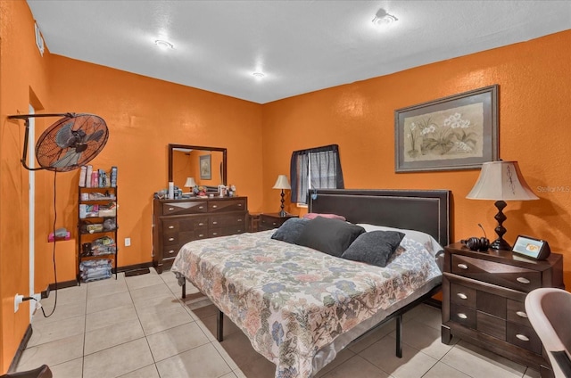 bedroom with baseboards and light tile patterned floors