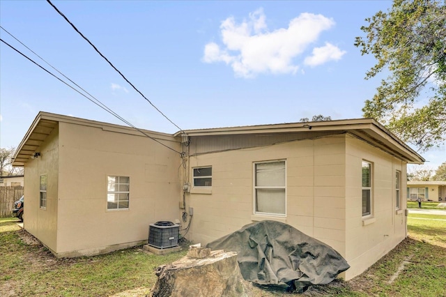 view of side of property featuring central air condition unit