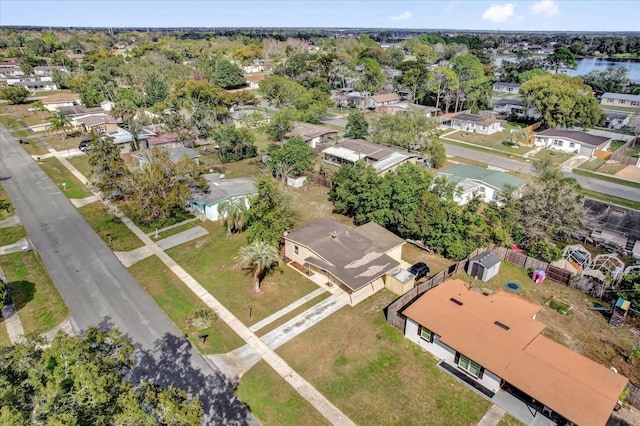 birds eye view of property with a water view and a residential view