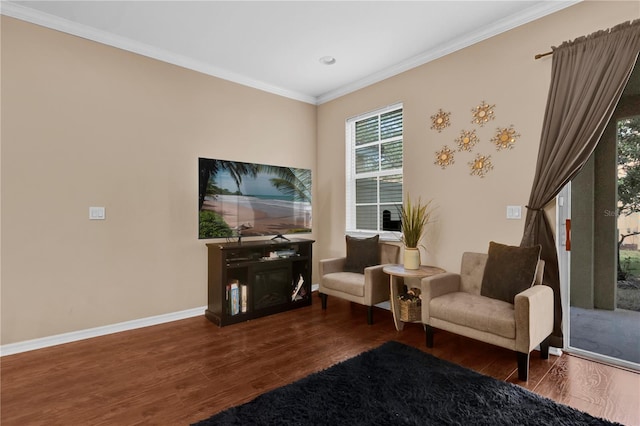 living area with ornamental molding, baseboards, and wood finished floors