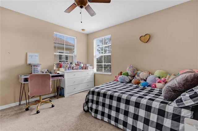 bedroom featuring light carpet, ceiling fan, and baseboards