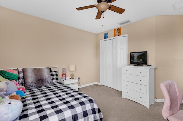 carpeted bedroom with a ceiling fan, baseboards, visible vents, and a closet