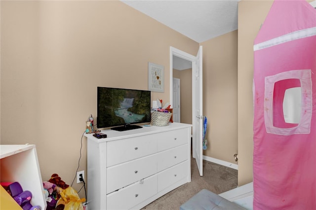 bedroom featuring baseboards and light colored carpet