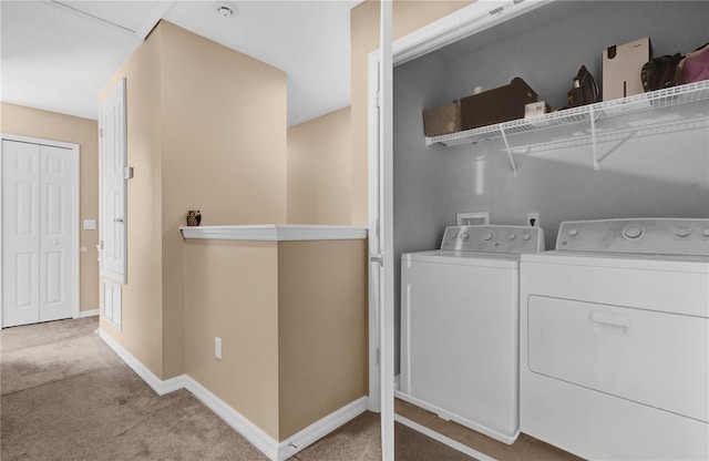 laundry area with baseboards, laundry area, carpet floors, and washer and dryer