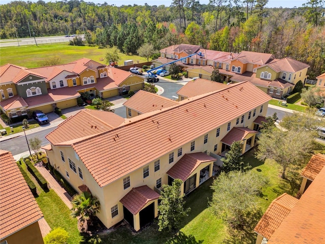 bird's eye view featuring a forest view and a residential view