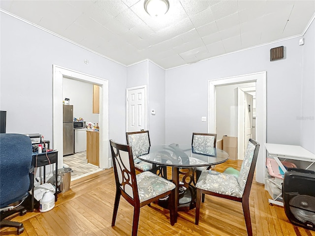 dining space with light wood-type flooring