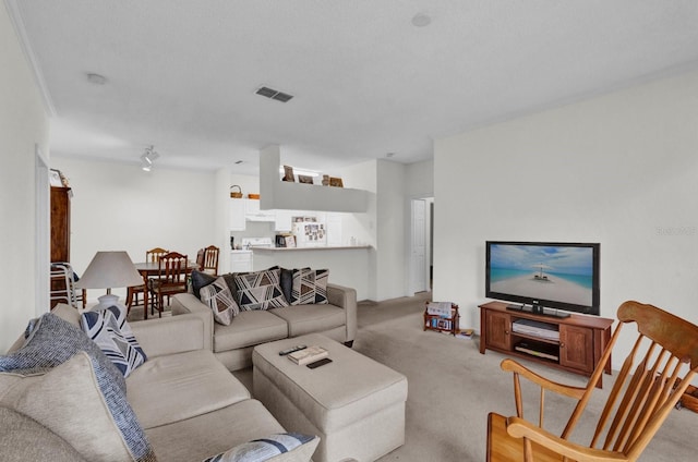 living area with light carpet and visible vents