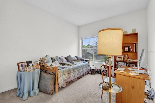 bedroom featuring baseboards and light colored carpet