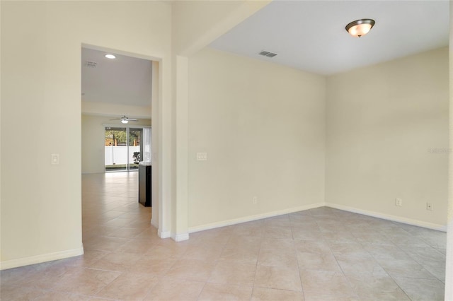 unfurnished room featuring light tile patterned floors, visible vents, and baseboards