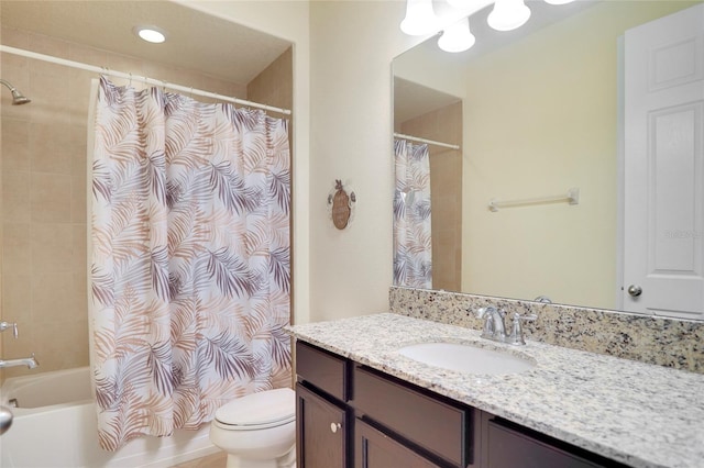 bathroom featuring toilet, shower / tub combo with curtain, and vanity