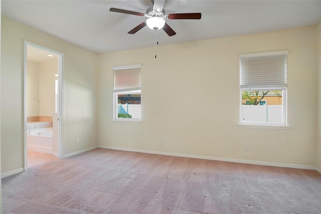 empty room with plenty of natural light, carpet, and baseboards