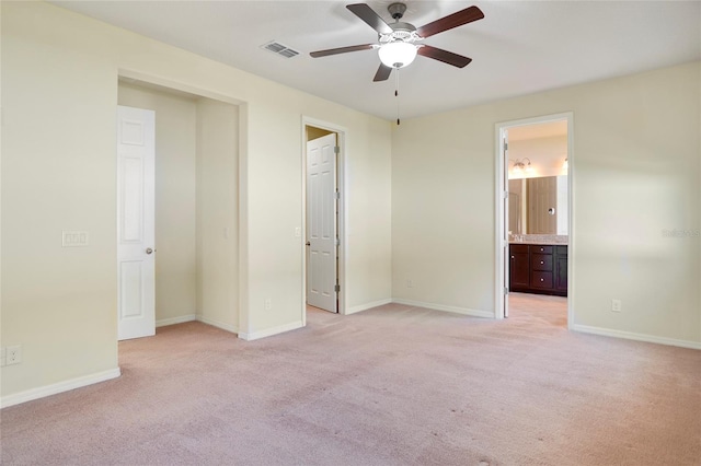 unfurnished bedroom with light carpet, visible vents, and baseboards