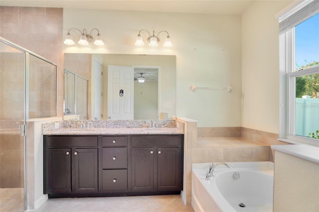 bathroom featuring a garden tub, double vanity, a stall shower, and a sink