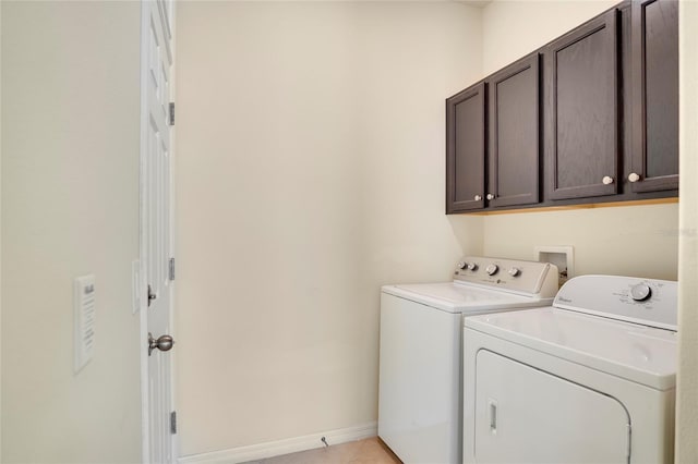 clothes washing area featuring cabinet space, light tile patterned floors, baseboards, and separate washer and dryer