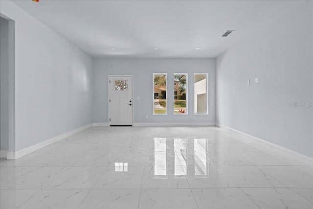 interior space with marble finish floor, visible vents, and baseboards