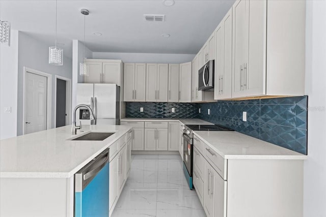 kitchen with stainless steel appliances, a sink, white cabinetry, marble finish floor, and decorative light fixtures