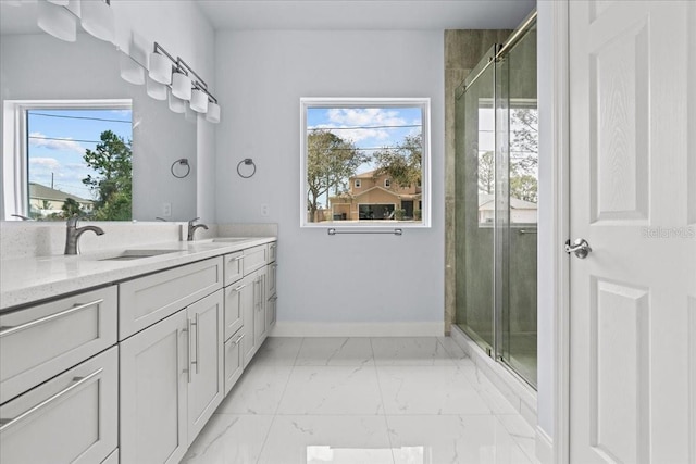 bathroom featuring marble finish floor, a shower stall, baseboards, and vanity