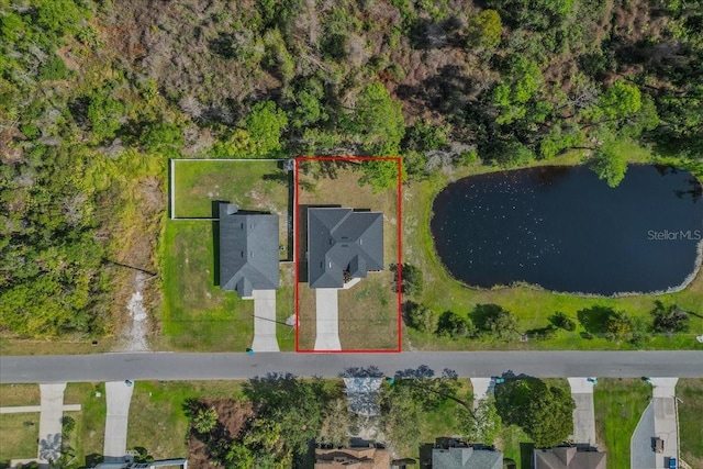 birds eye view of property with a water view