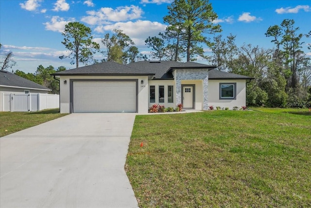 view of front of property with driveway, a front lawn, an attached garage, and fence