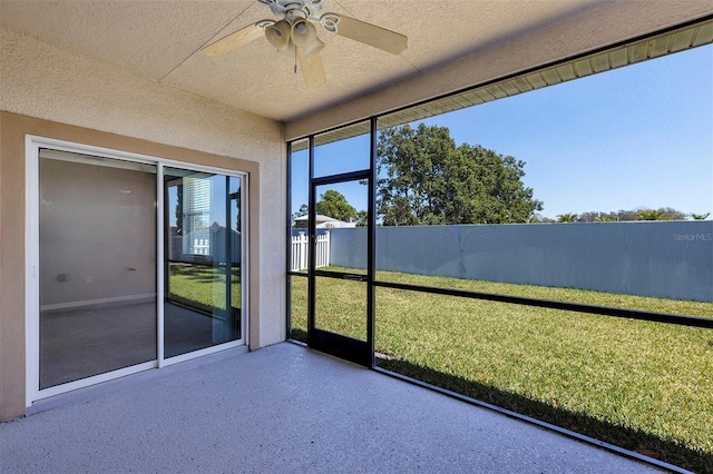 unfurnished sunroom featuring ceiling fan