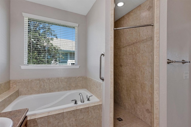 full bath featuring vanity, a garden tub, and a stall shower