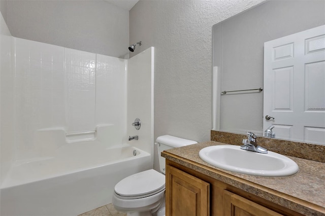 bathroom with vanity, toilet, a textured wall, and shower / bathtub combination