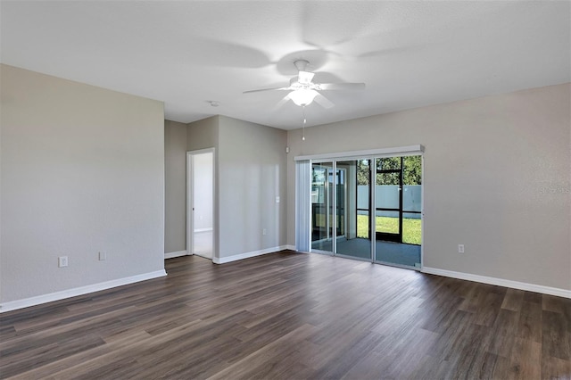 spare room featuring dark wood-style floors, baseboards, and ceiling fan